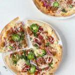 tortilla pizza with sausage, kale, and jalapeno